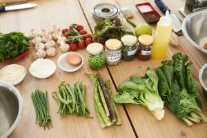 wooden table with a range of fresh ingredients on top