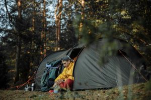 man camping alone in wilderness