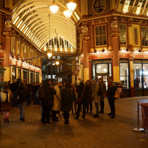 illuminated Victorian shopping centre with warm lights and people crowded